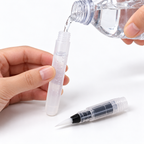 Filling a transparent water brush pen reservoir with clean water.