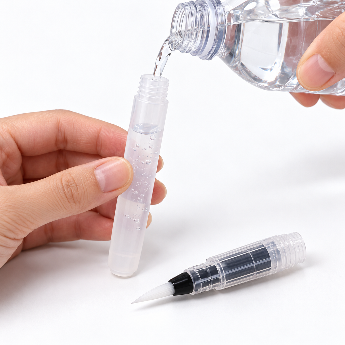 Filling a transparent water brush pen reservoir with clean water.