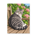 A silver tabby cat sitting on a wooden bench among leafy plants and pink flowers - animal paint by numbers artwork
