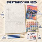 Seattle Sunset paint by numbers kit showing numbered canvas, paint pots, three brushes, color reference and guide