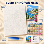 Coastal Village paint by numbers kit showing numbered canvas, paint pots, three brushes, reference and guide