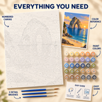 Sunset Sea Arch paint by numbers kit showing numbered canvas, paint pots, three brushes, color reference and painting guide